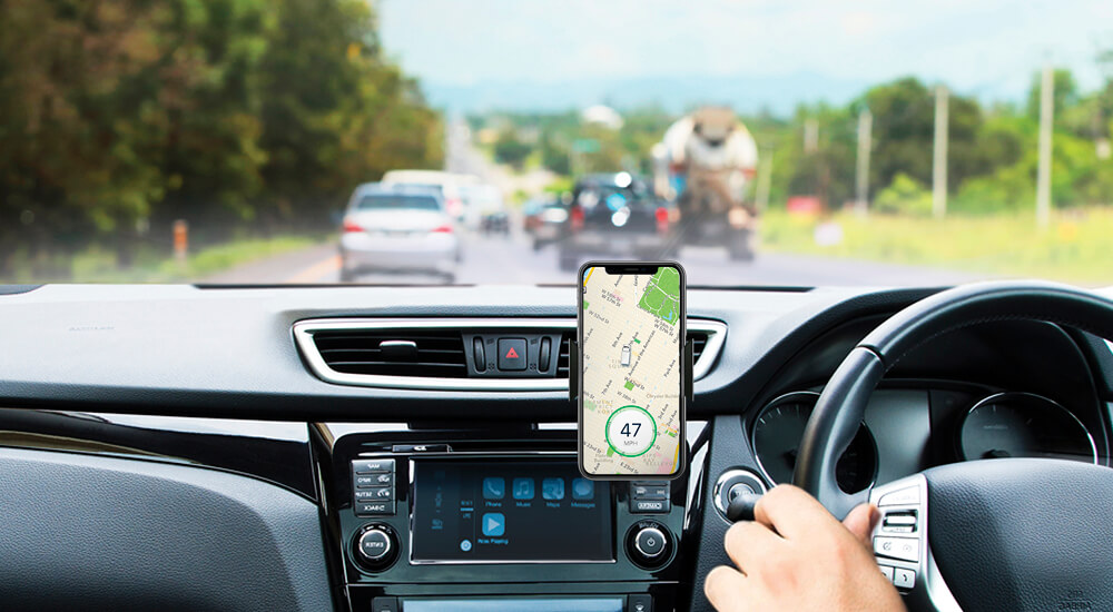 Smart phone showing map attached to car dashboard.